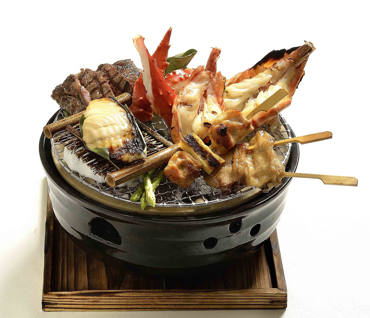 A yakitori grill running on lump charcoal in a working kitchen