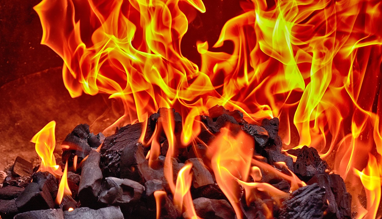 Traditional earth kiln carbonising hardwood at the factory — Best Lump Charcoal for Smoking: What to Look For