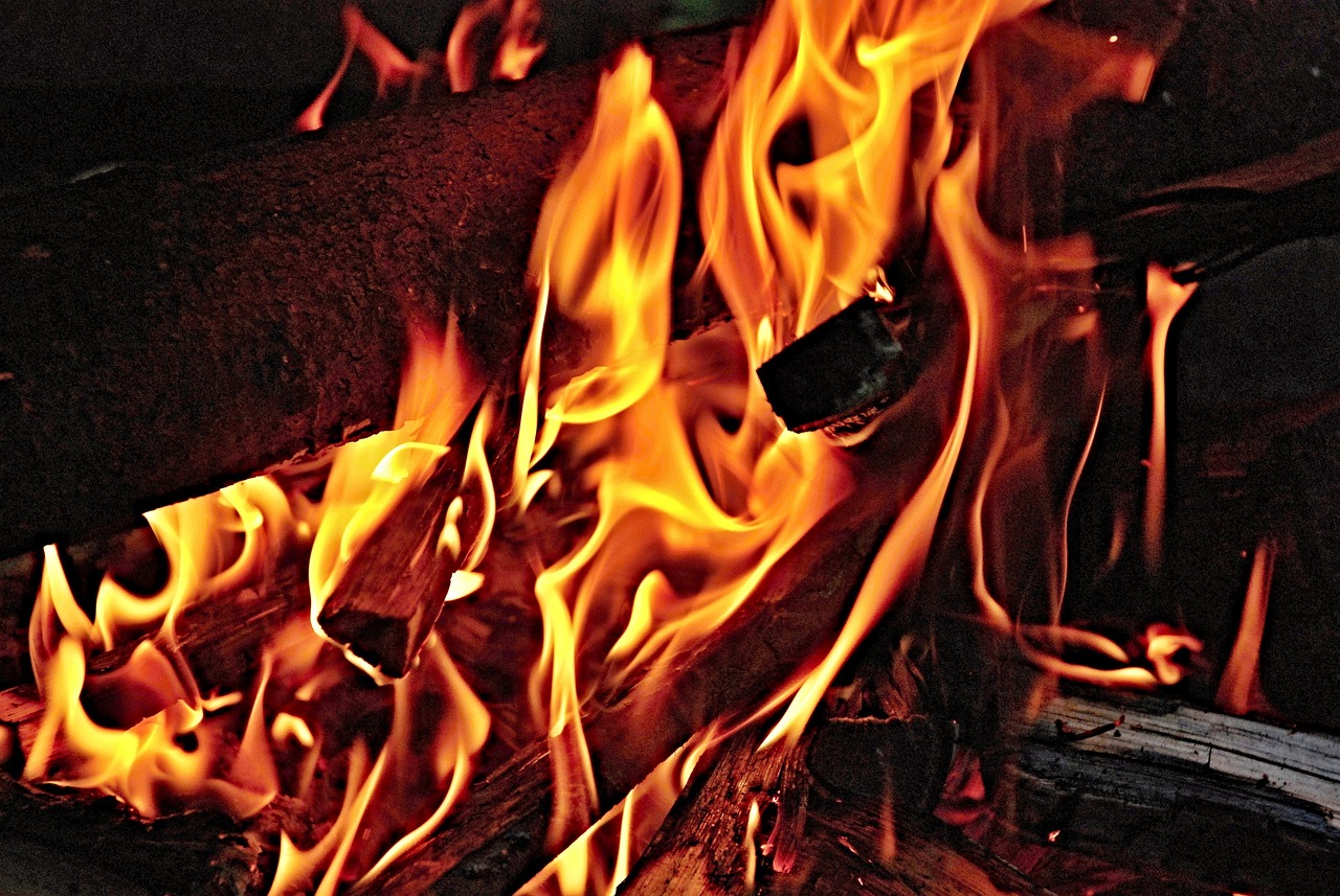 Traditional earth kiln carbonising hardwood at the factory