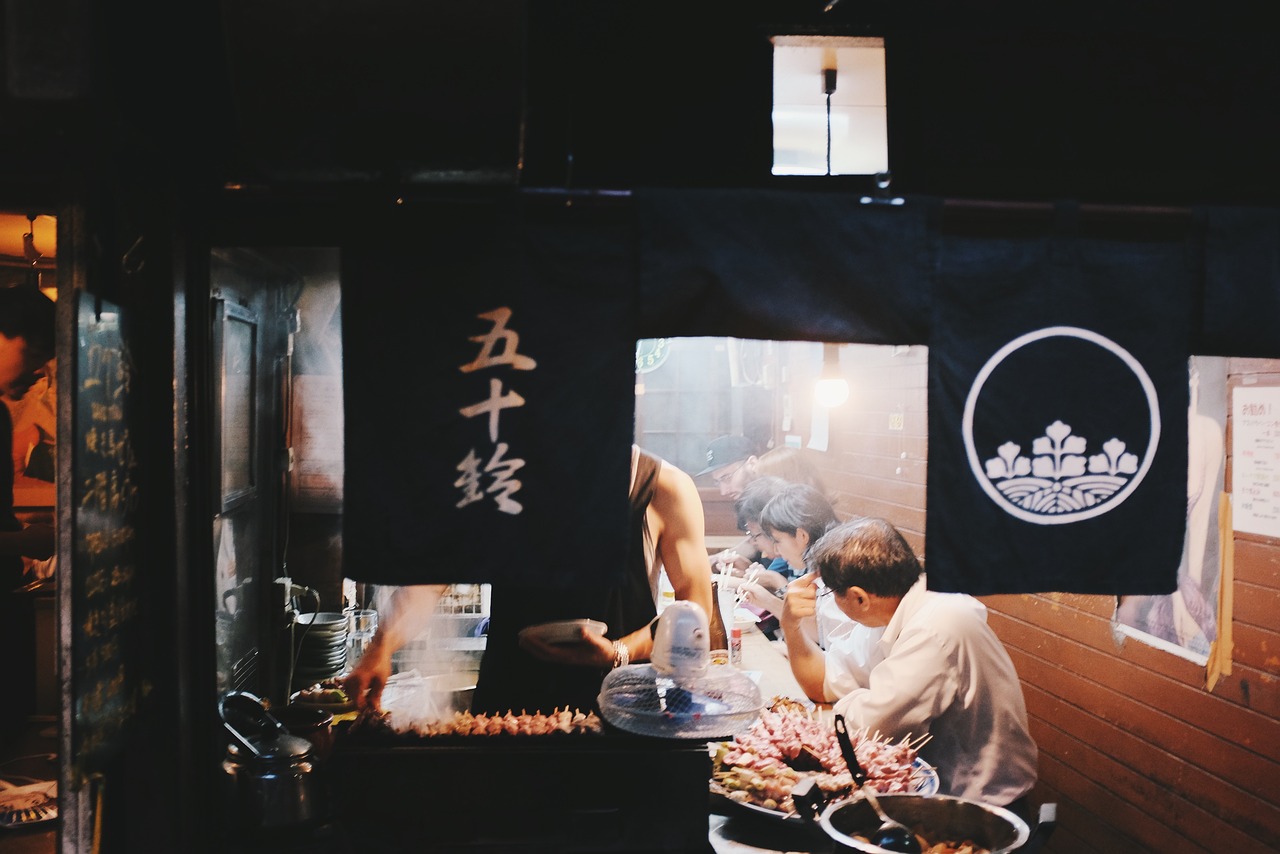 A yakitori grill running on lump charcoal in a working kitchen — Charcoal Grilling for Beginners