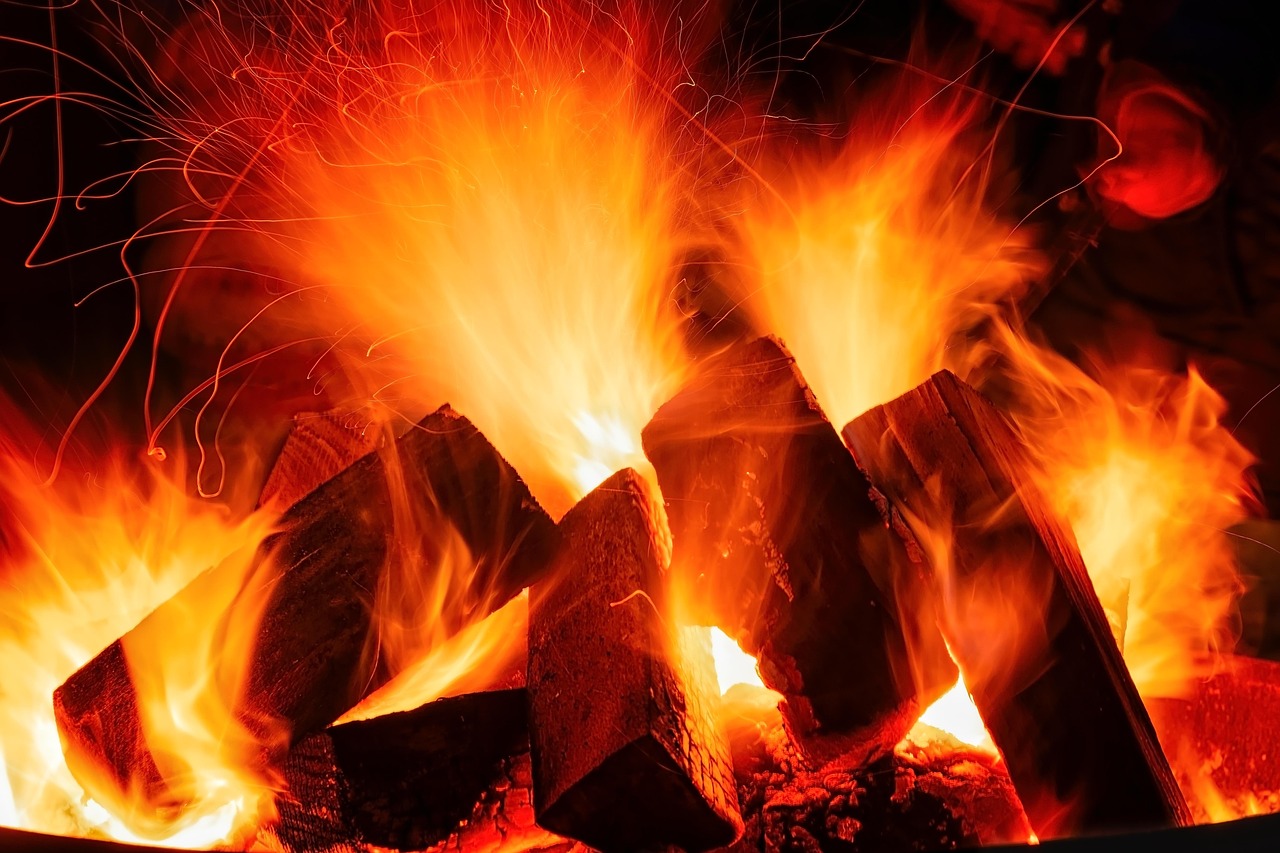 Traditional earth kiln carbonising hardwood at the factory