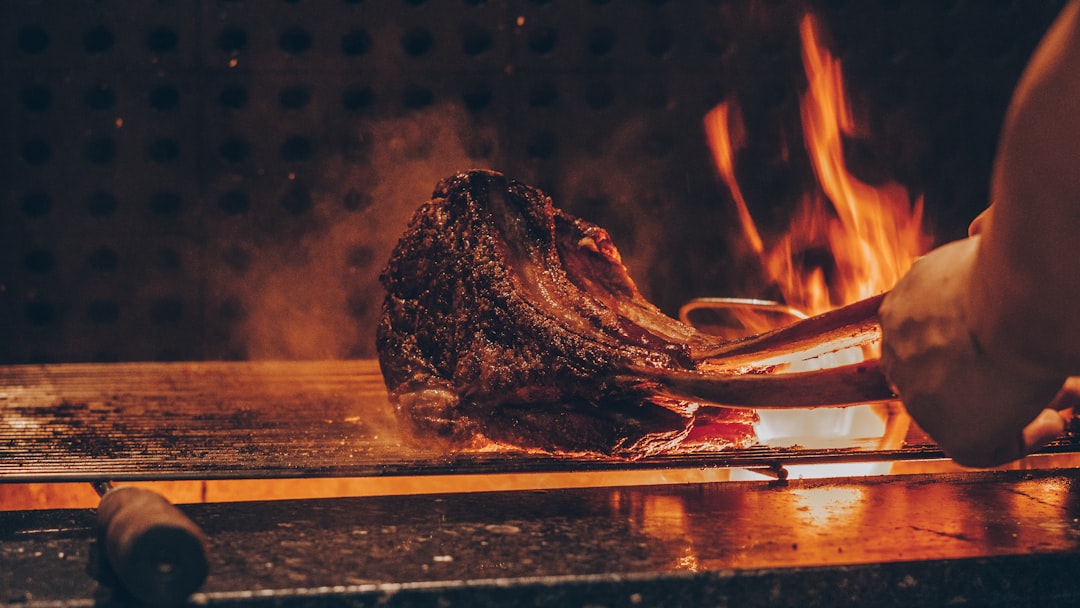 Hardwood charcoal fire searing at high heat for a proper crust on the grill