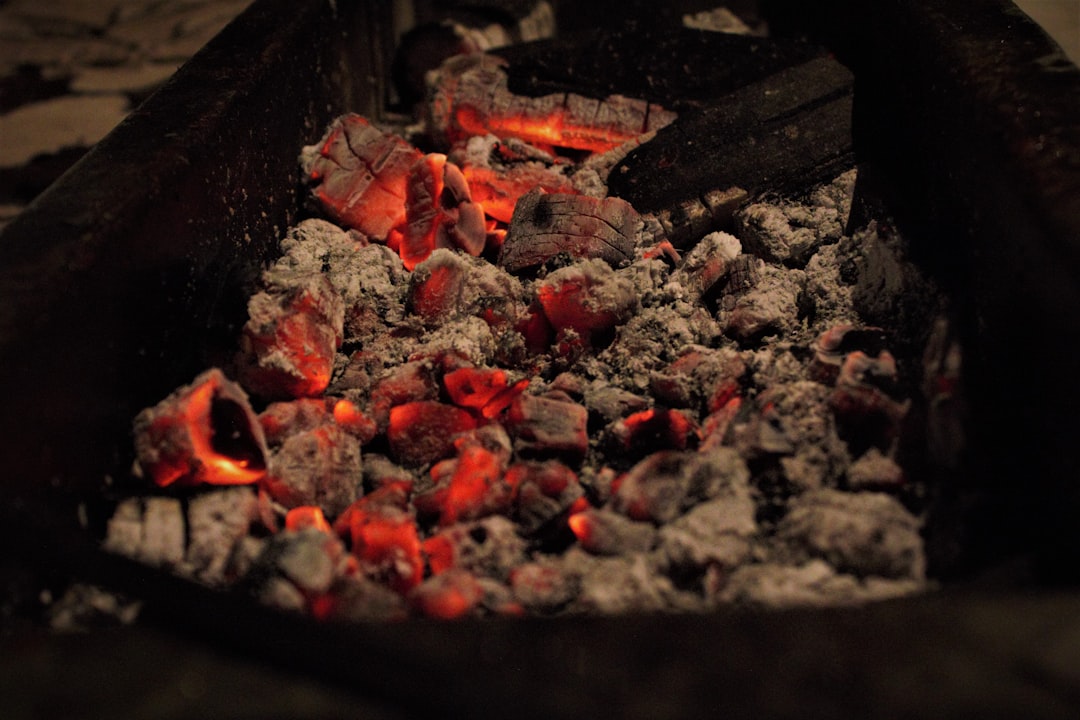 A traditional earth kiln under fire during the carbonisation stage of charcoal manufacturing