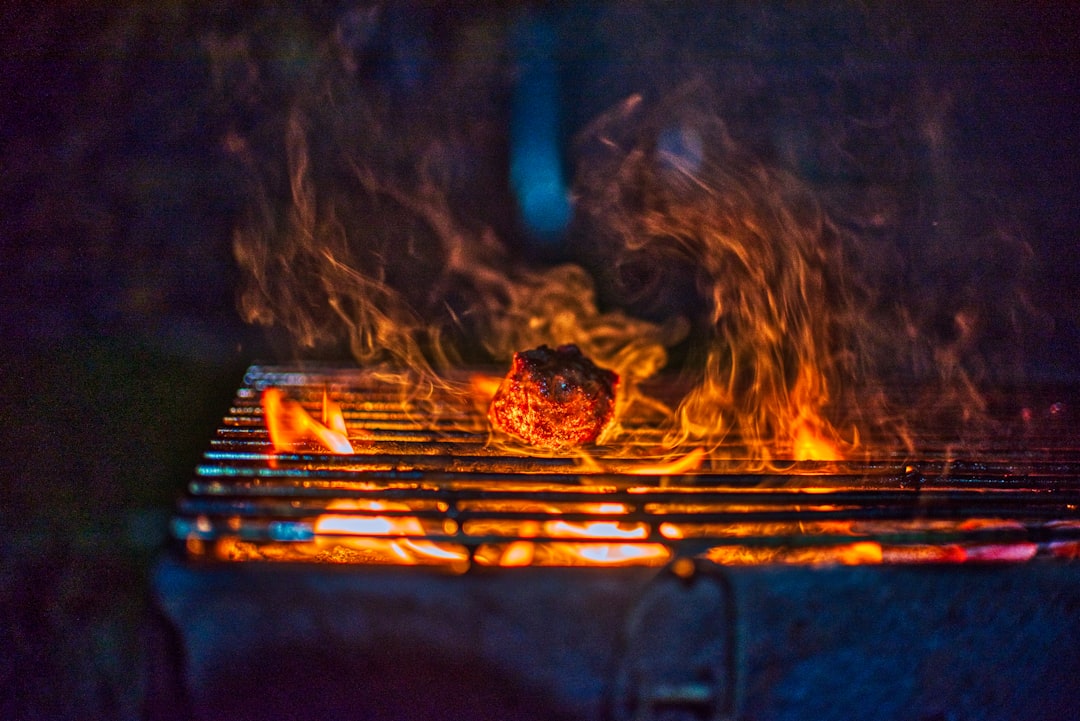Smoke and sparks off a charcoal bed, the signature of fuel that still carries moisture