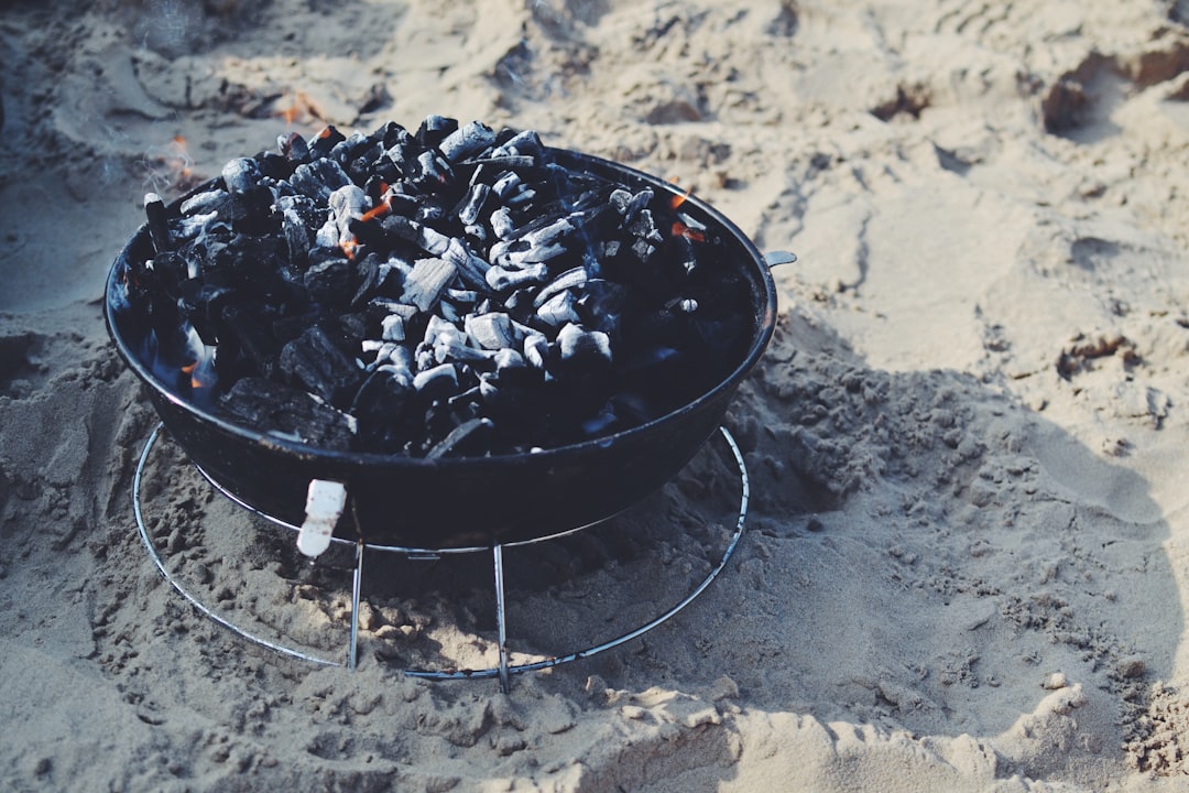 An even grey ash coat over a red core: the sign the load is ready to cook on
