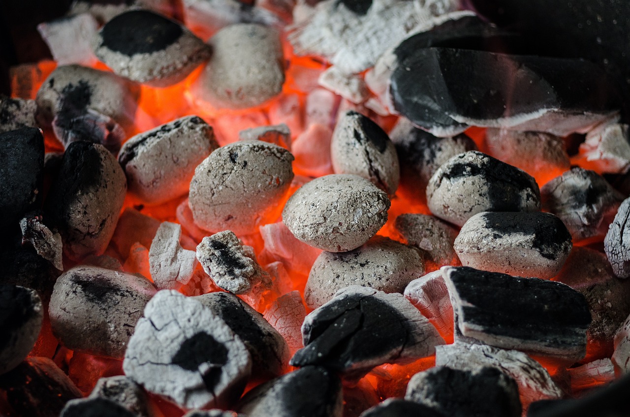 A charcoal bed burning down to steady ember heat with almost no flame
