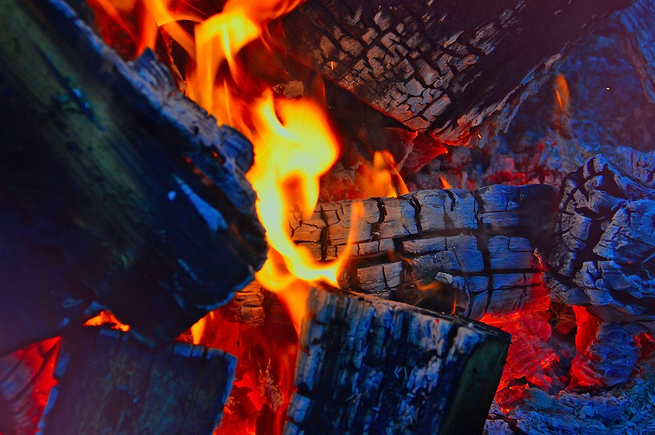 Traditional earth kiln carbonising hardwood at the factory