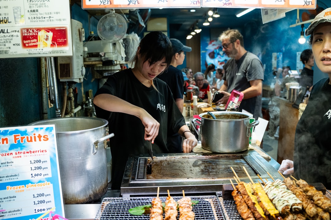 A yakitori counter at service, where binchotan holds a steady fire through a full dinner shift