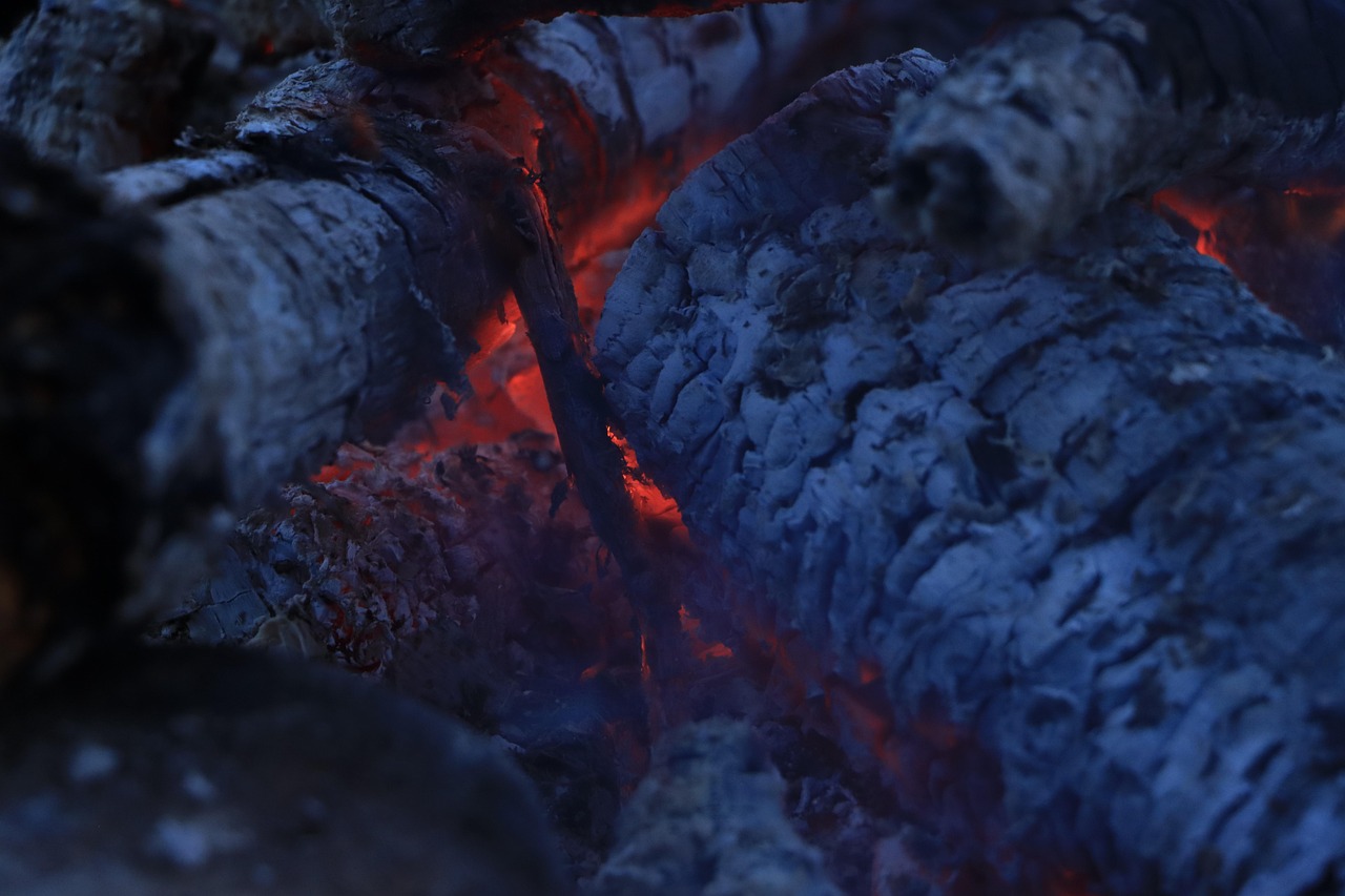 Traditional earth kiln carbonising hardwood at the factory