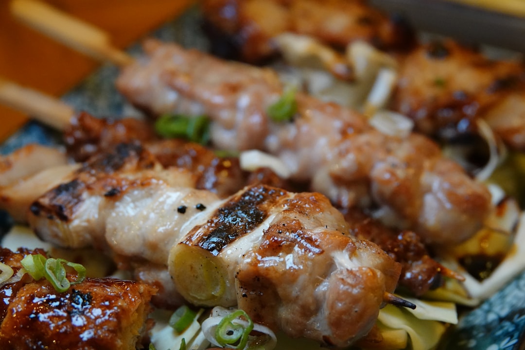 Skewers cooking over a binchotan bed on a yakitori grill