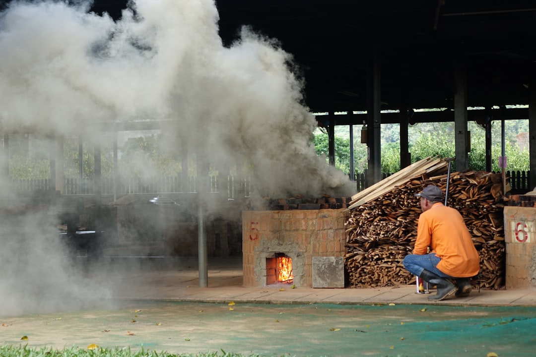 A working carbonisation yard, where hardwood is converted under controlled heat