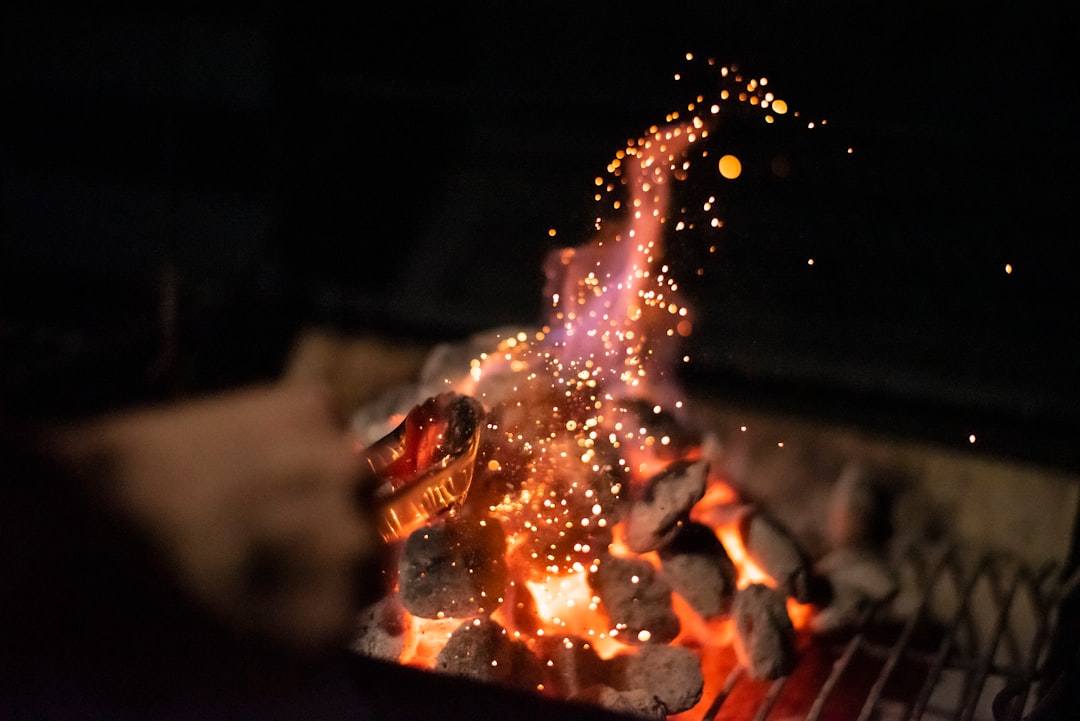 Lump charcoal glowing on an open grill, ready for high heat searing