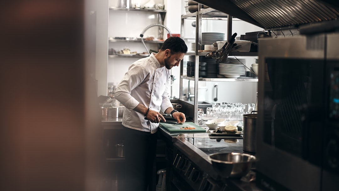 A chef working over live fire, the setting where white charcoal earns its price